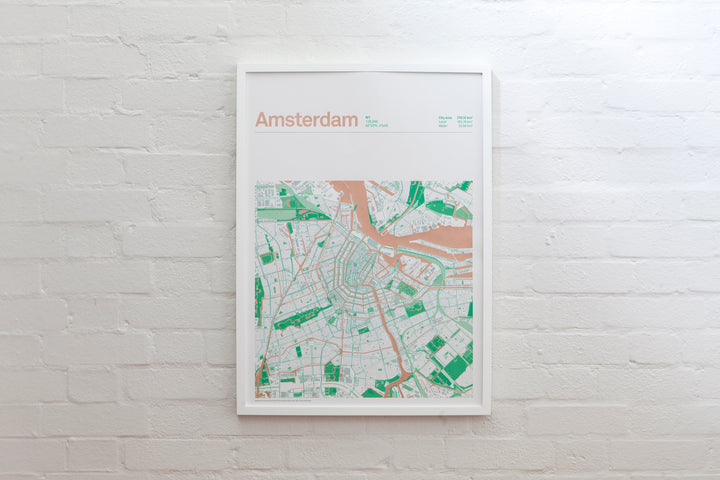 Copper Amsterdam map print displayed in a white frame, with copper waterways and green parks.